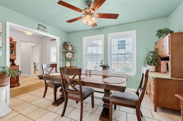 tiled dining room with ceiling fan