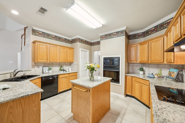 kitchen with light stone counters, sink, a kitchen island, and black appliances