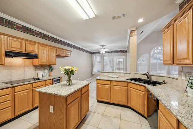 kitchen with sink, light stone counters, beverage cooler, decorative backsplash, and black appliances