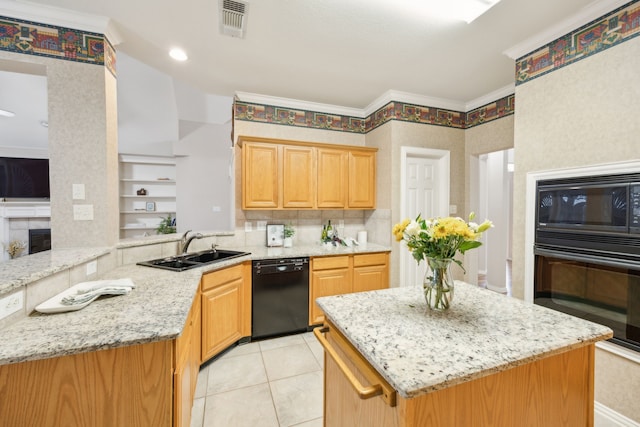 kitchen with light stone counters, sink, black appliances, and kitchen peninsula