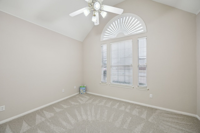 spare room featuring ceiling fan, light colored carpet, and lofted ceiling