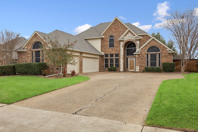 view of front property featuring a garage and a front yard