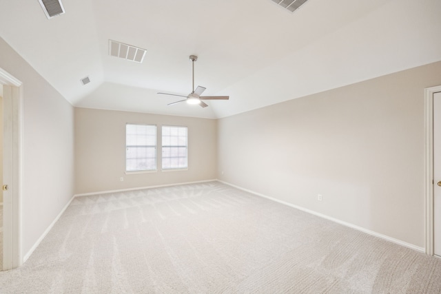 carpeted empty room featuring vaulted ceiling and ceiling fan