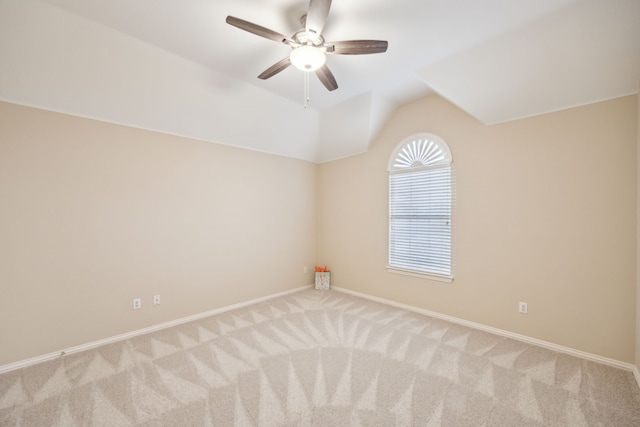 carpeted spare room with lofted ceiling and ceiling fan