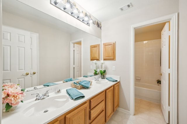 bathroom with vanity and tiled shower / bath combo