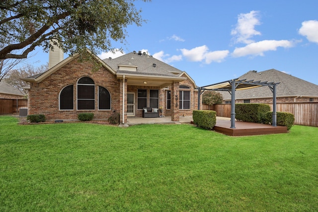 rear view of house with central AC unit, a yard, a pergola, and a patio