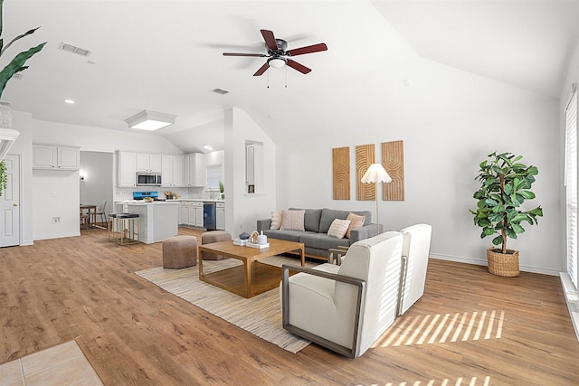 living room featuring ceiling fan, high vaulted ceiling, and light wood-type flooring