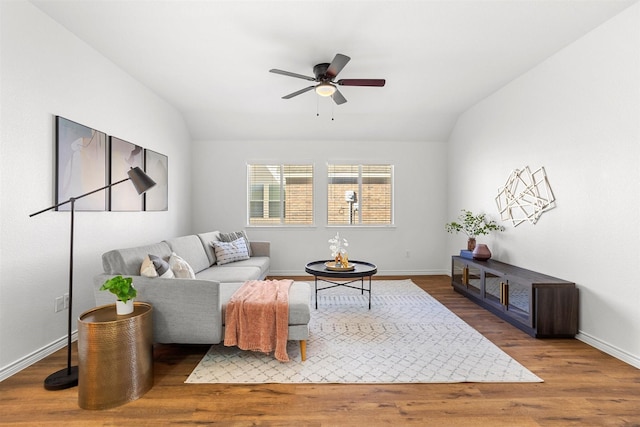 living room with lofted ceiling, hardwood / wood-style floors, and ceiling fan