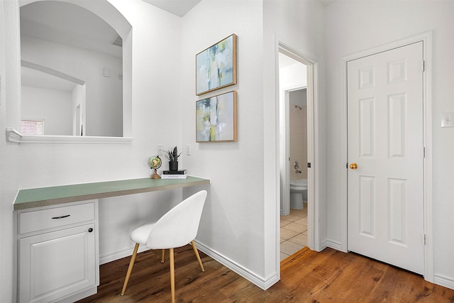 bathroom featuring wood-type flooring and toilet