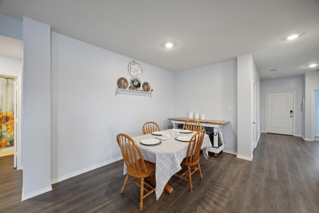 dining room with dark hardwood / wood-style flooring