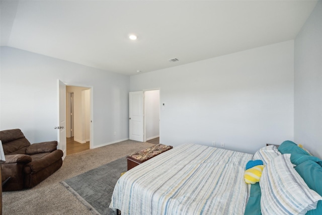 carpeted bedroom with lofted ceiling