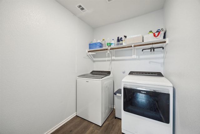 washroom featuring dark hardwood / wood-style floors and washer and clothes dryer