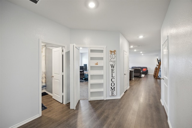 corridor featuring dark wood-type flooring