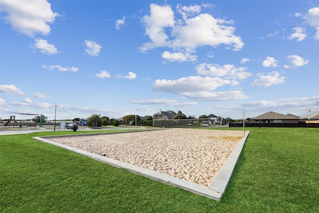 view of property's community with a lawn and volleyball court