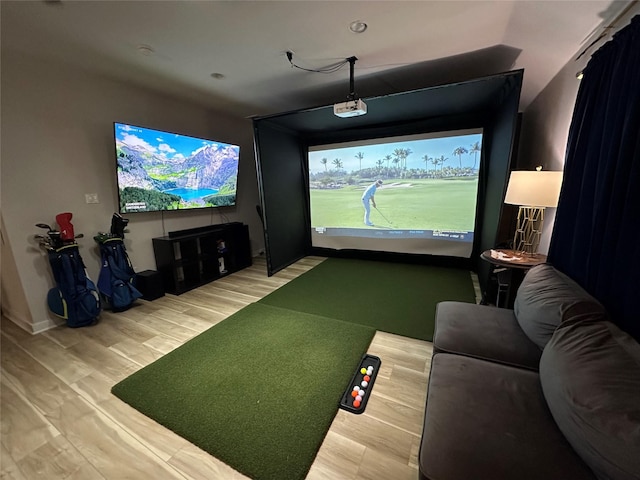 recreation room with golf simulator and light wood-type flooring