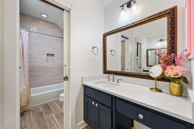 bathroom featuring vanity, hardwood / wood-style floors, and toilet