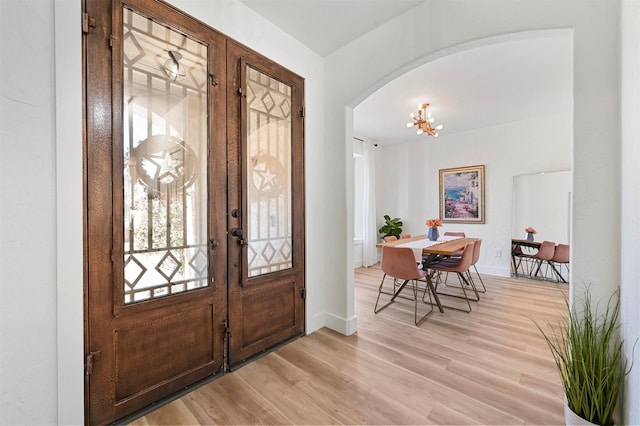 entrance foyer with an inviting chandelier and light wood-type flooring