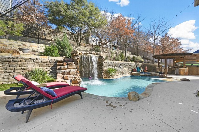 view of swimming pool featuring an in ground hot tub and a patio area