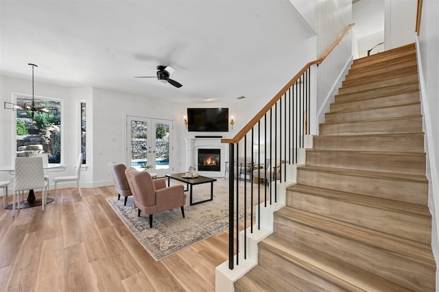 living room with hardwood / wood-style flooring, french doors, and ceiling fan