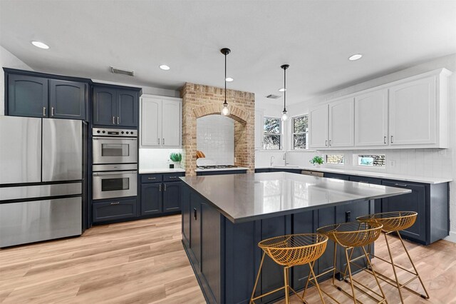 kitchen featuring sink, backsplash, light stone countertops, white cabinets, and stainless steel dishwasher