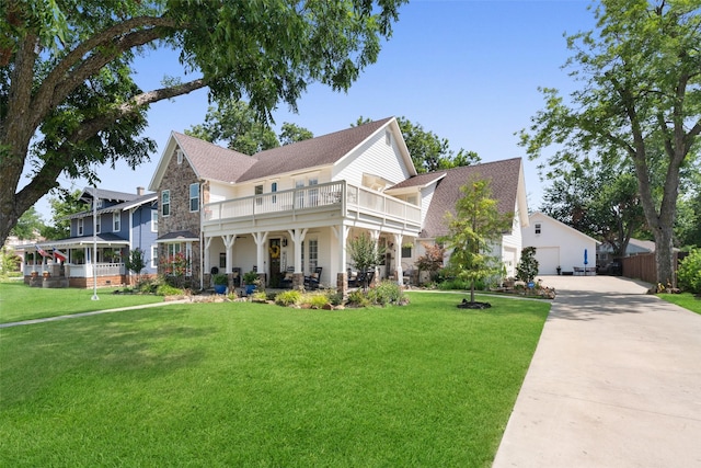 view of front of property featuring a balcony and a front yard