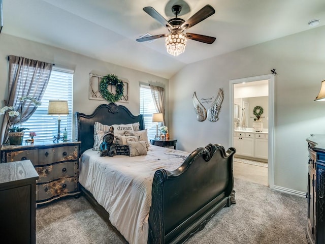 carpeted bedroom featuring ceiling fan, connected bathroom, and vaulted ceiling