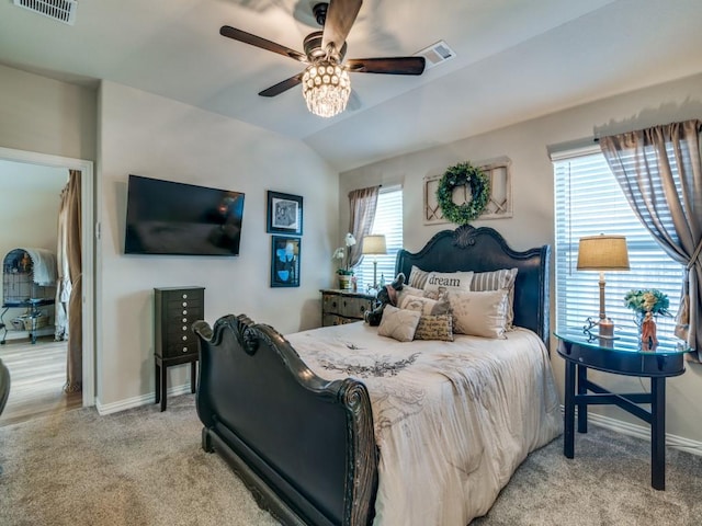 carpeted bedroom featuring multiple windows, lofted ceiling, and ceiling fan