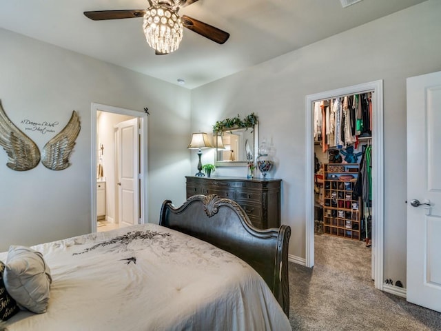 bedroom featuring carpet, a spacious closet, ceiling fan, ensuite bath, and a closet