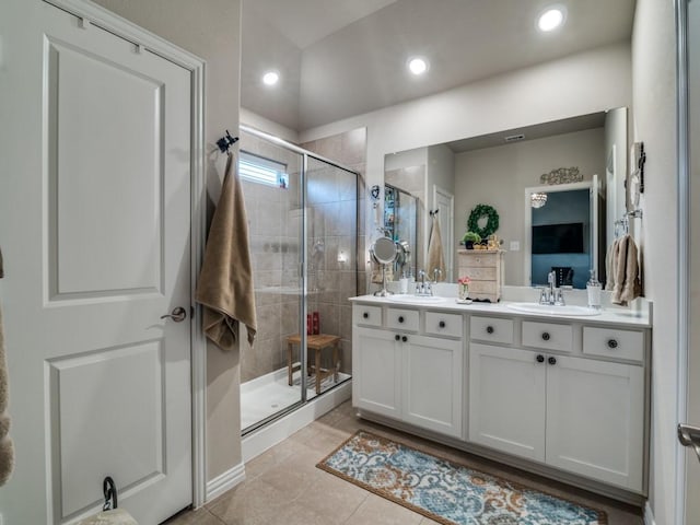 bathroom featuring vanity, tile patterned floors, and walk in shower