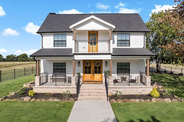 view of front of home featuring a porch, a front lawn, and french doors