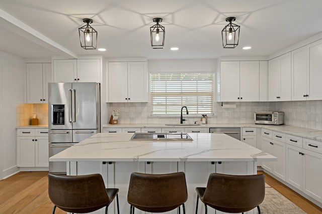 209 Mary Fitch Rd, Sherman, TX 75090 - kitchen with stainless steel appliances, a sink, recessed lighting, white cabinets, and decorative backsplash