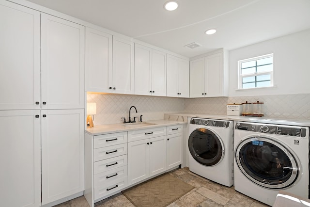 209 Mary Fitch Rd, Sherman, TX 75090 - laundry room with washing machine and clothes dryer, cabinet space, recessed lighting, and light stone finish floors