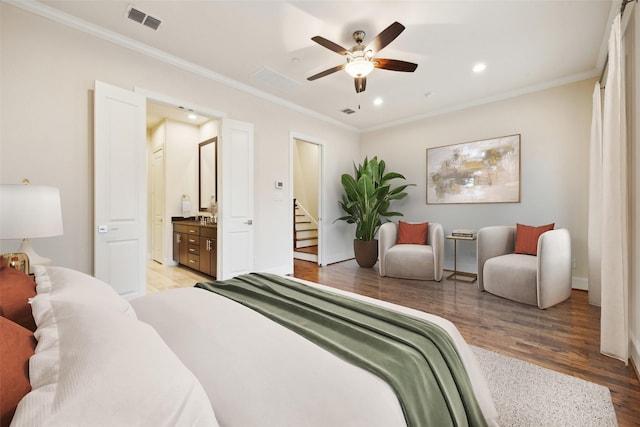 bedroom featuring ornamental molding, ensuite bathroom, ceiling fan, and light hardwood / wood-style floors