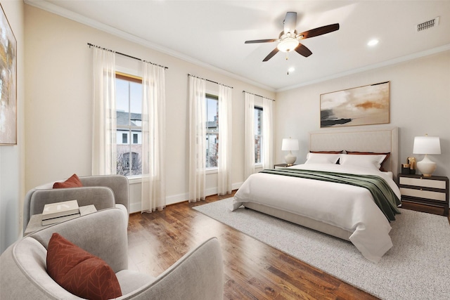 bedroom with wood-type flooring, ceiling fan, and crown molding