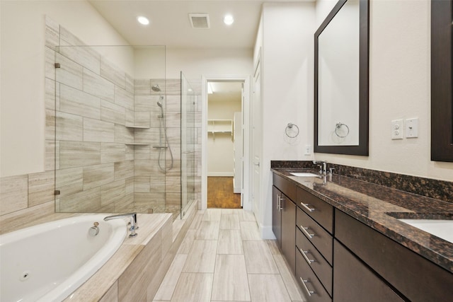 bathroom with vanity and plus walk in shower