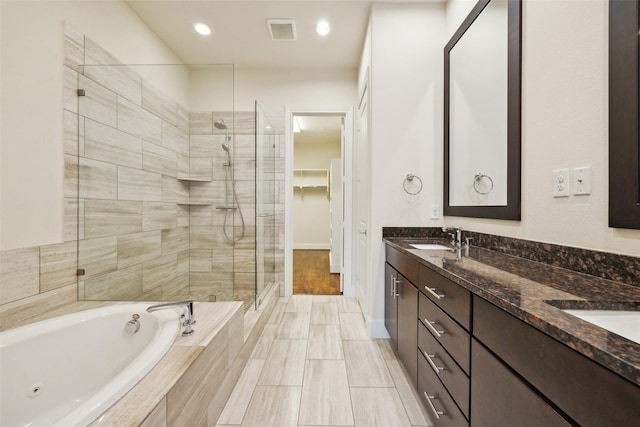 2134 Canton St, Dallas, TX 75201 - bathroom featuring a whirlpool tub, a sink, a stall shower, visible vents, and double vanity