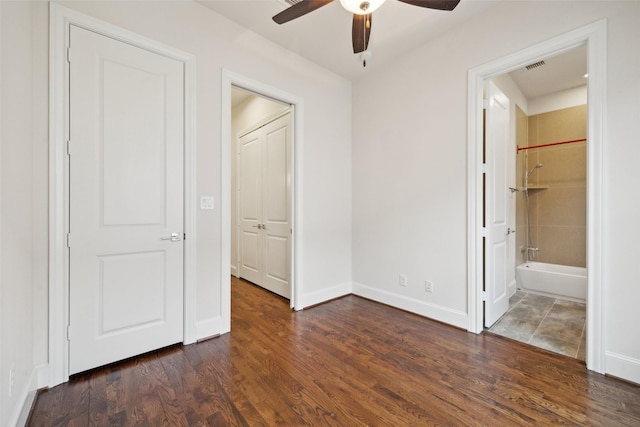 2134 Canton St, Dallas, TX 75201 - unfurnished bedroom featuring baseboards, ensuite bathroom, visible vents, and dark wood finished floors