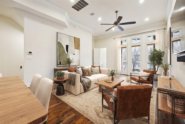 living room with ornamental molding, dark hardwood / wood-style floors, and ceiling fan