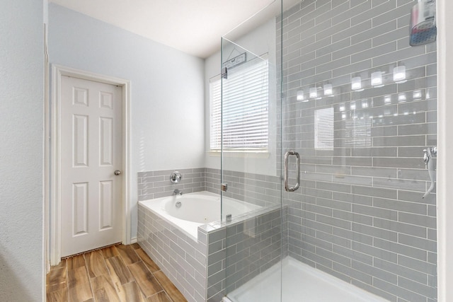 bathroom with shower with separate bathtub and hardwood / wood-style floors