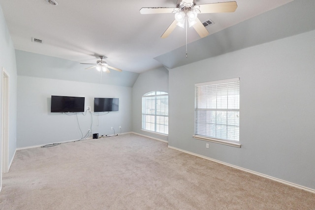 unfurnished living room featuring ceiling fan, lofted ceiling, and light carpet