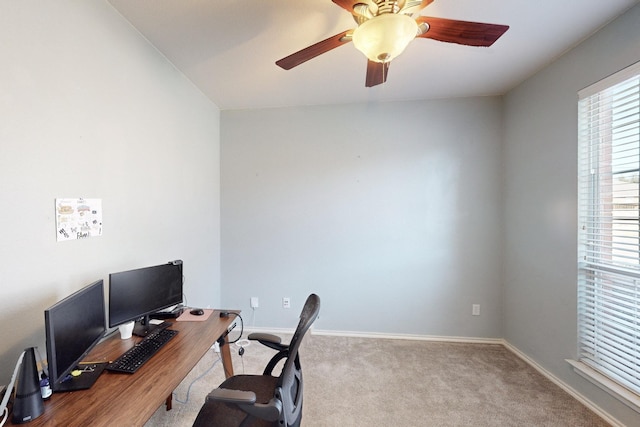 carpeted office space with ceiling fan