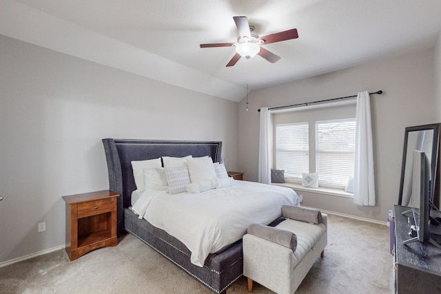 bedroom with ceiling fan, vaulted ceiling, and light carpet