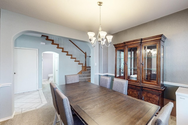 unfurnished dining area with an inviting chandelier and light colored carpet