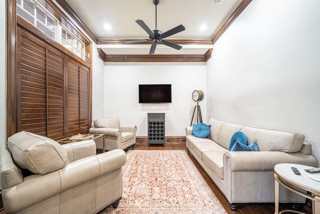 living room featuring wood-type flooring, ceiling fan, and crown molding