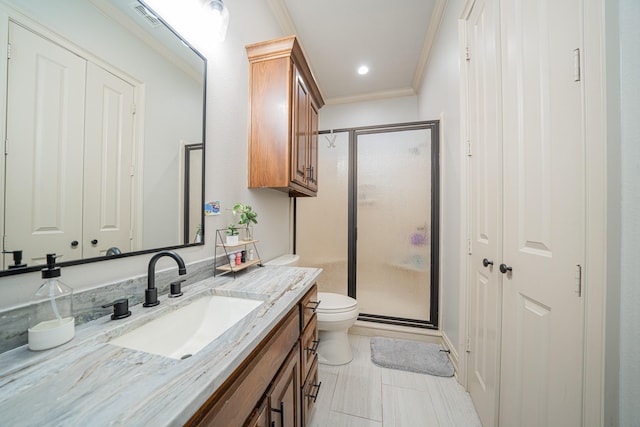 bathroom featuring vanity, ornamental molding, walk in shower, toilet, and tile patterned floors