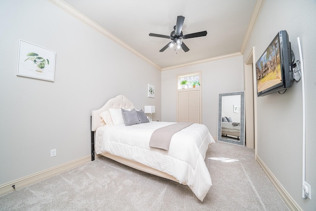 carpeted bedroom featuring ornamental molding and ceiling fan