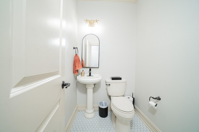 bathroom with tile patterned flooring and toilet