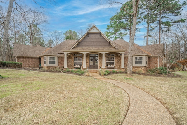 craftsman inspired home featuring a porch and a front yard