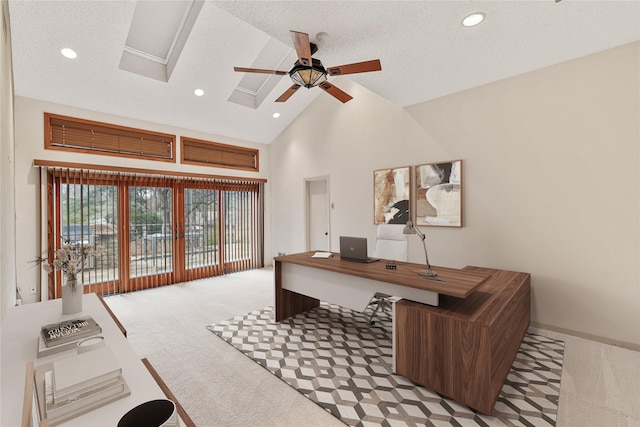 carpeted office space with high vaulted ceiling, a textured ceiling, and ceiling fan