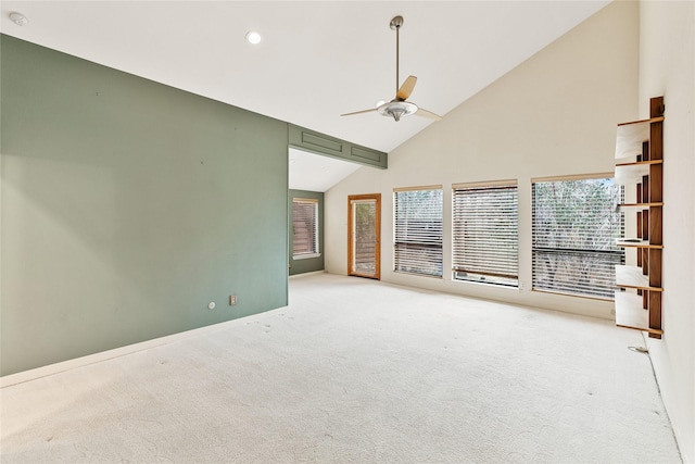 carpeted empty room featuring high vaulted ceiling and ceiling fan